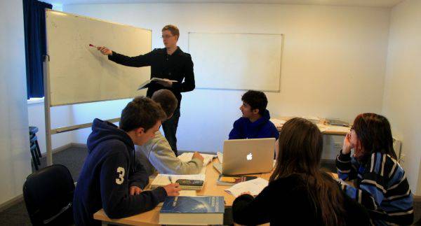 Students receiving academic support in one of the college study rooms